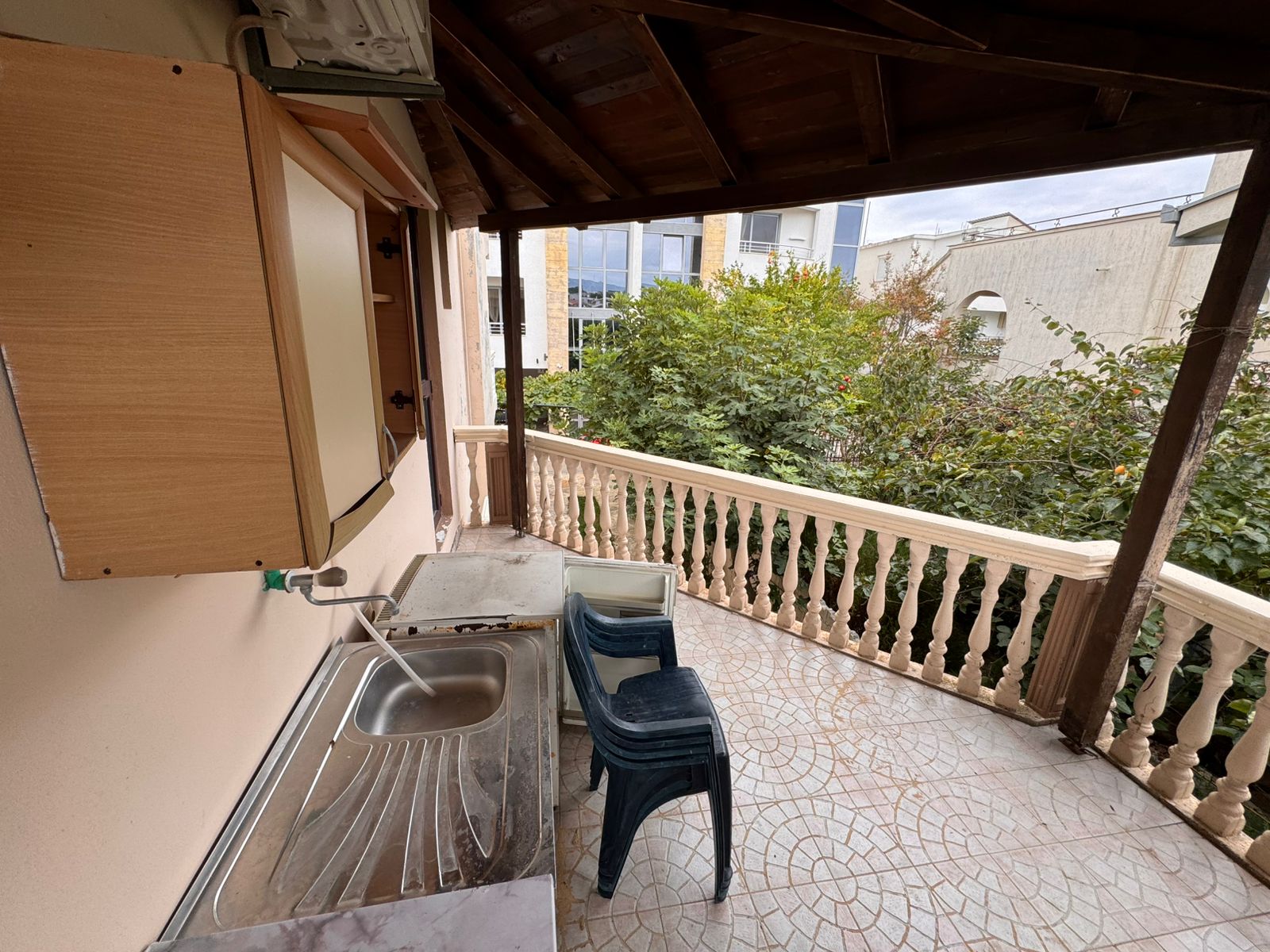 Charming tiled balcony in Ulcinj with outdoor kitchen, storage, and scenic views—ideal Montenegro investment by ekosphere doo.