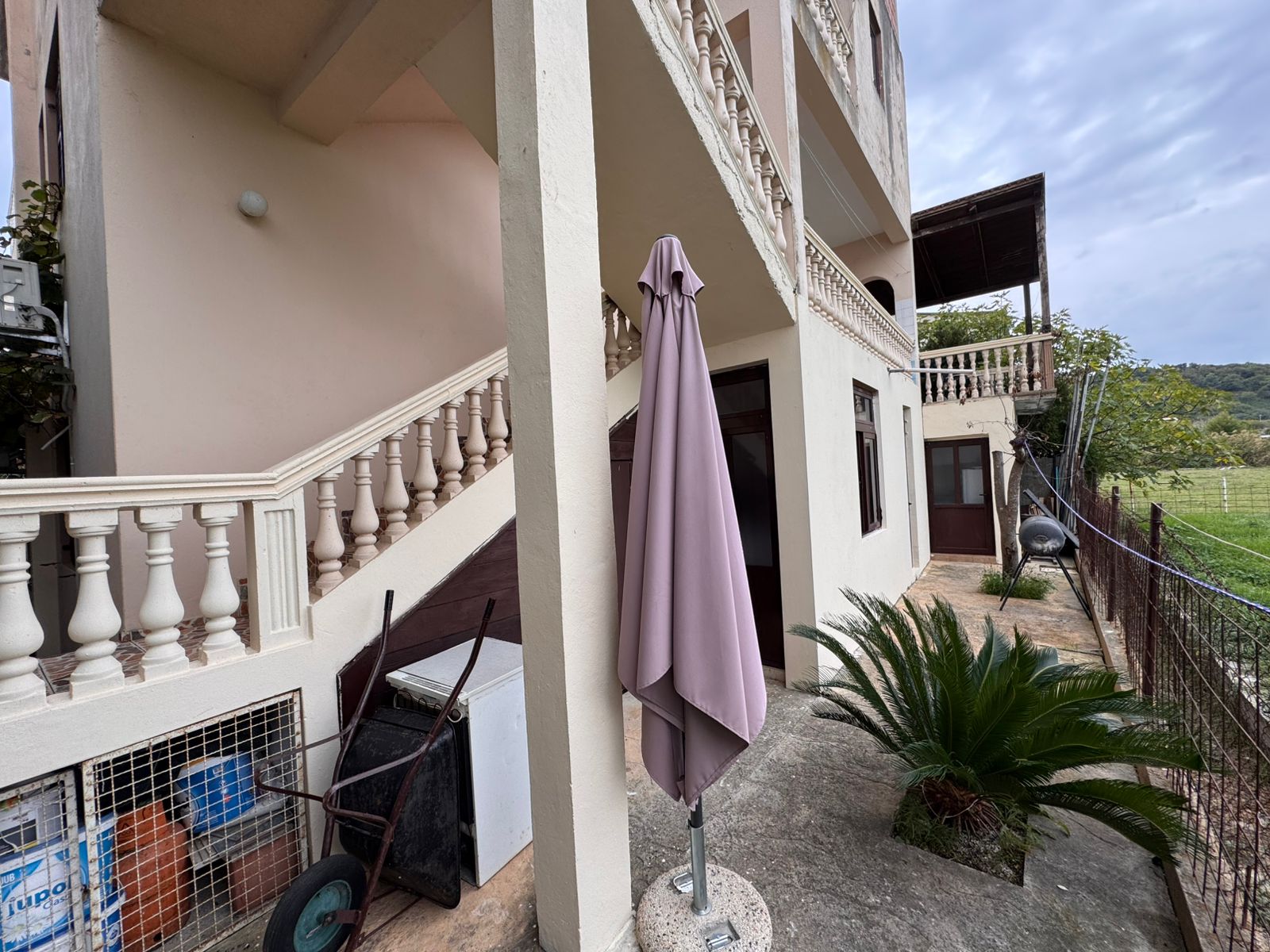 Modern beige two-story home in Ulcinj, Montenegro with private patio and garden, ideal for investment; listed on montenegro-listings.me.