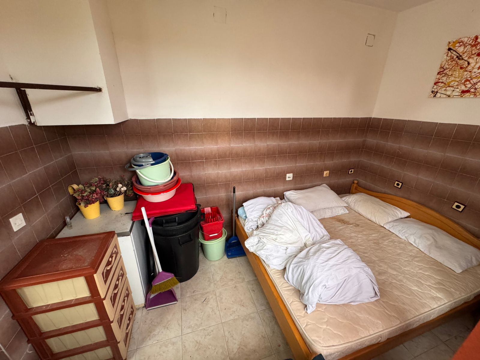 Charming Ulcinj investment: cozy tiled room with double bed, storage, and potential. Listed by montenegro-listings.me, ekosphere doo.