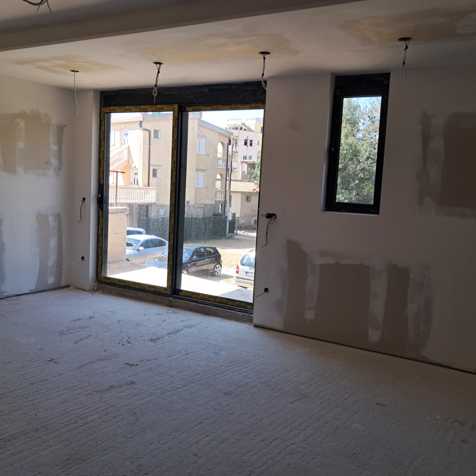 Spacious unfinished room in Ulcinj, Montenegro, ideal for investment. Large windows with street views. Exclusive at montenegro-listings.me, a project of ekosphere doo.