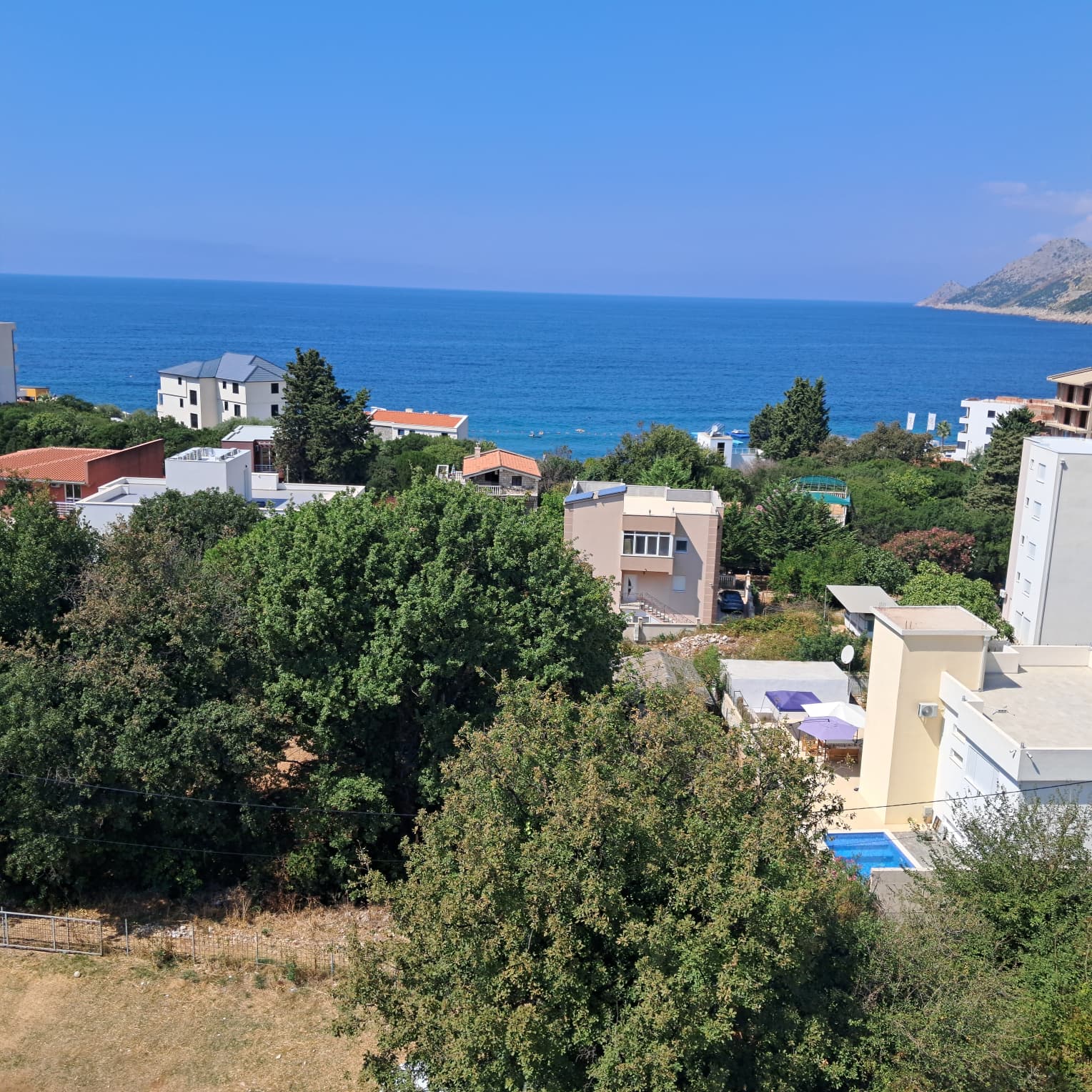 Exclusive Ulcinj homes nestled in greenery, stunning sea views, and mountain backdrop. Invest via montenegro-listings.me by ekosphere doo.