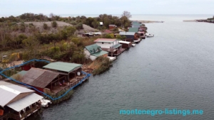 Exclusive investment opportunity: waterfront houses with private docks in Ulcinj, Montenegro—highlighted green-roof property by ekosphere doo.