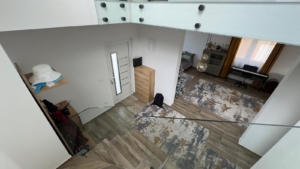 Stylish Ulcinj home with modern glass stairwell, elegant entry, bright living area, and piano—prime investment at montenegro-listings.me.
