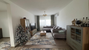 Stunning Ulcinj apartment: modern living room, gray sectional sofa, large windows, stylish decor. Exclusive at montenegro-listings.me by ekosphere doo.