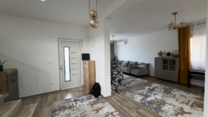 Elegant Ulcinj living room with wood floors, modern décor, and festive touches—prime Montenegro real estate from ekosphere doo.