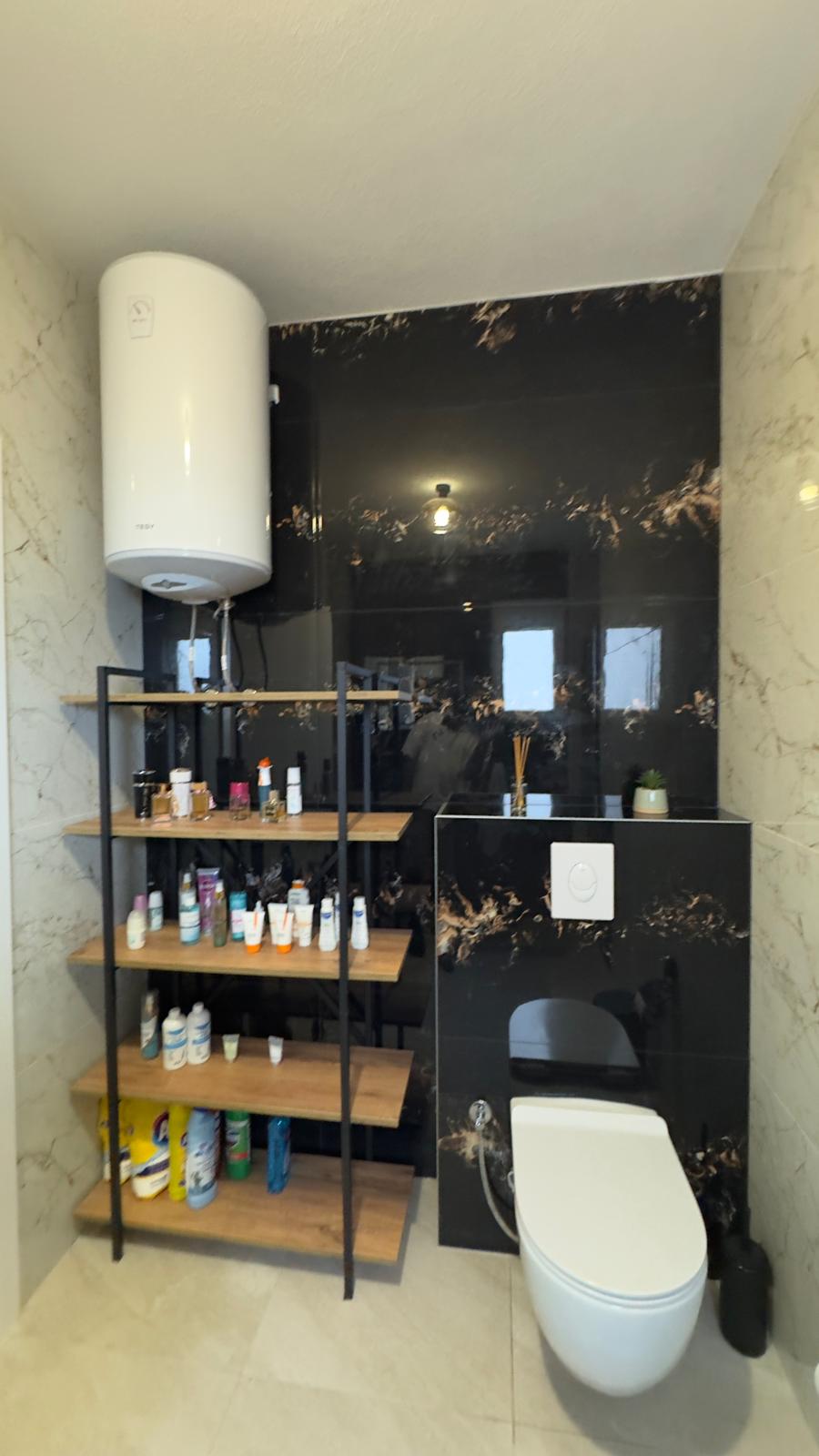 Luxurious Ulcinj bathroom with beige and black marble, modern fixtures, ideal for property investment. Montenegro-listings.me by ekosphere doo.