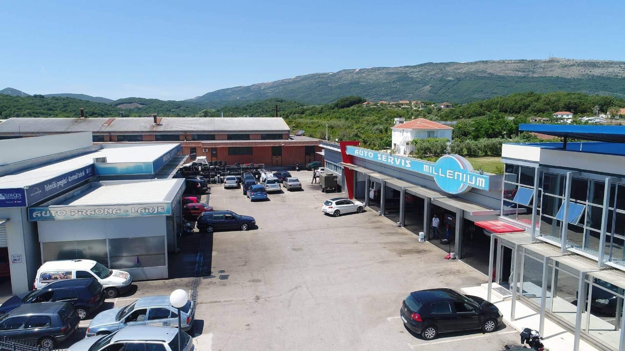 Prime commercial property in Ulcinj, Montenegro: spacious paved lot with auto shops, scenic hills&mdash;ideal investment at montenegro-listings.me.