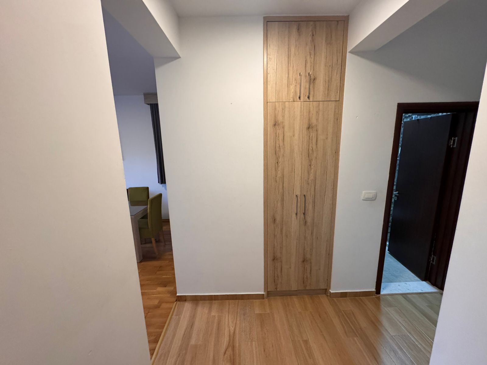 Bright hallway with modern wood flooring, quality storage, and access to stylish dining&mdash;Prime Ulcinj property at montenegro-listings.me.