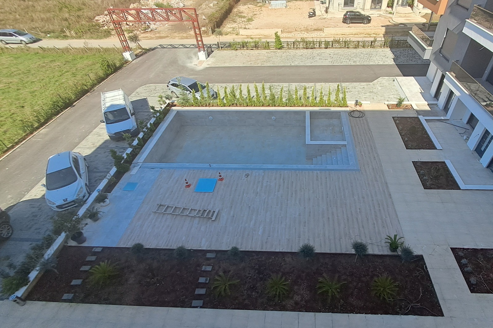 Spacious paved courtyard with rectangular pool, decorative greenery; excellent Ulcinj real estate from montenegro-listings.me by ekosphere doo.
