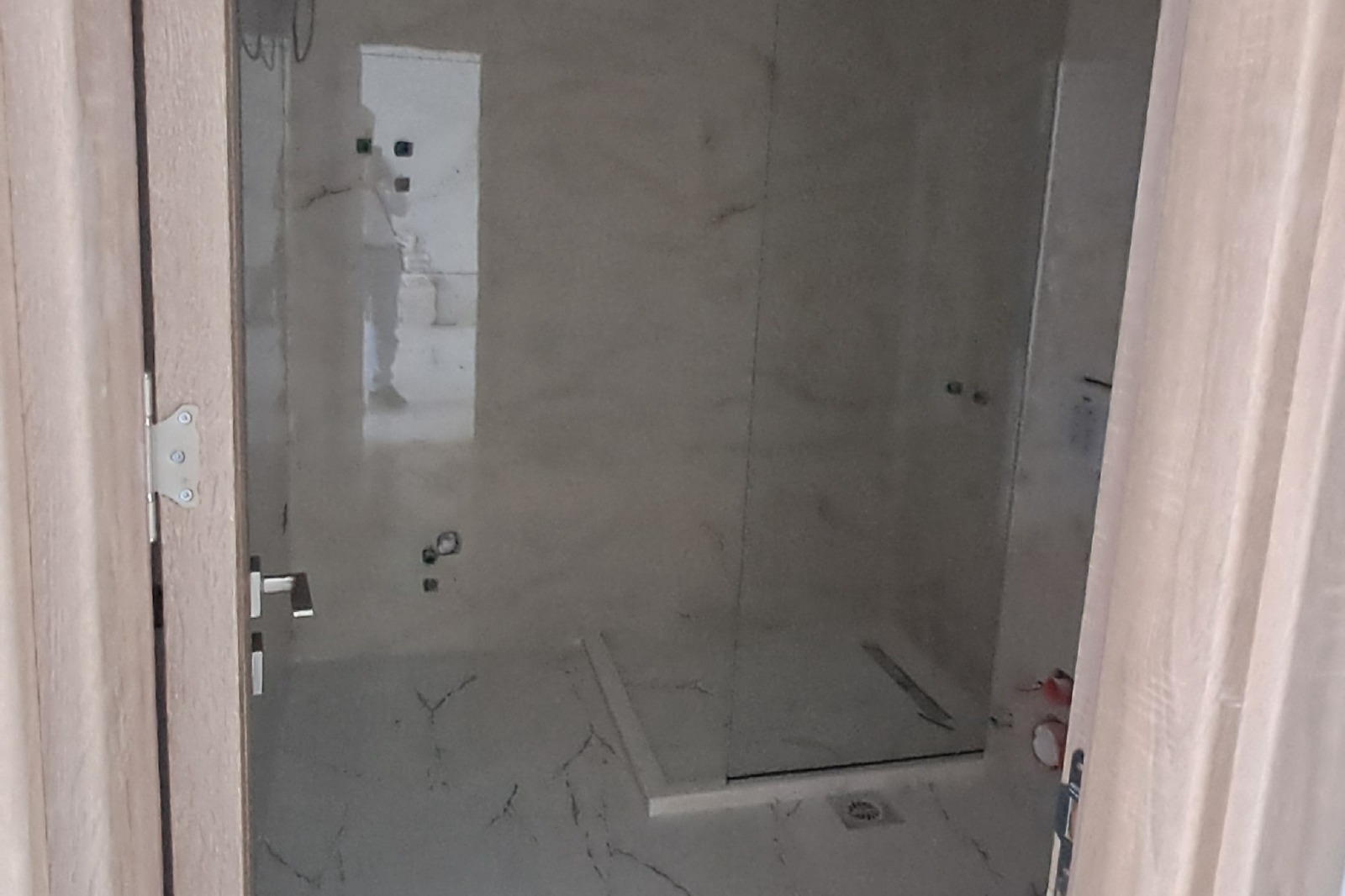 Modern bathroom in progress with elegant marble-style finishes and walk-in shower—prime Ulcinj investment at montenegro-listings.me.