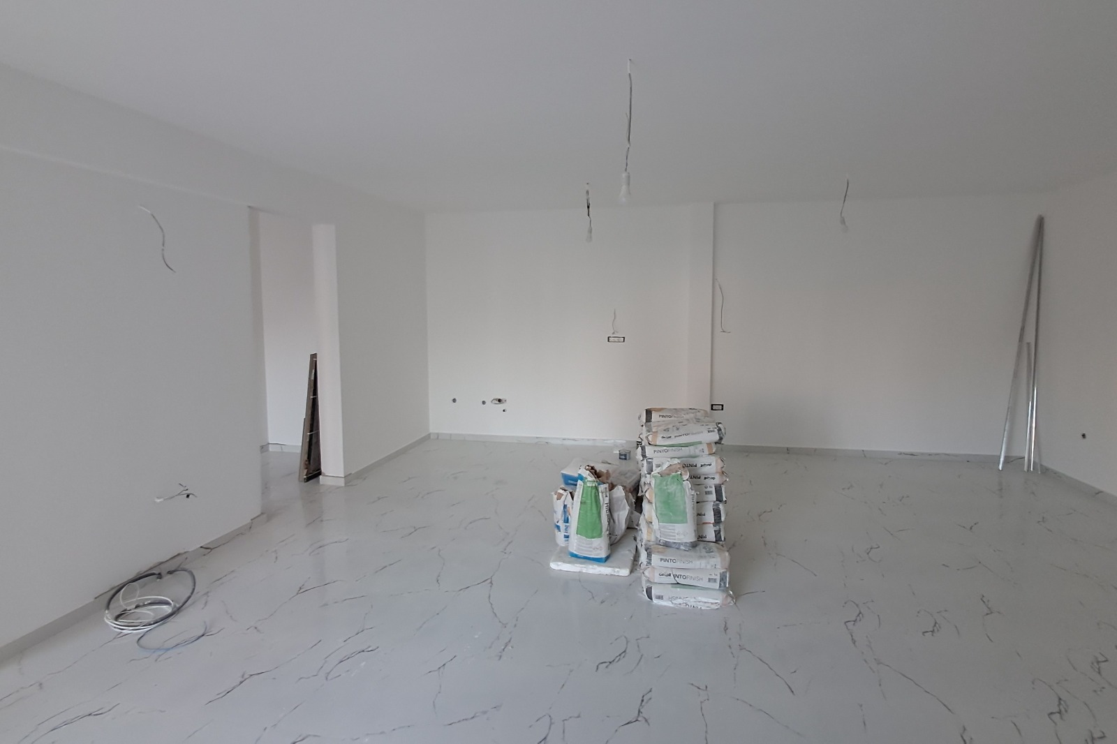 Spacious Ulcinj property under renovation with white walls, stylish flooring, and investment potential—montenegro-listings.me by ekosphere doo.