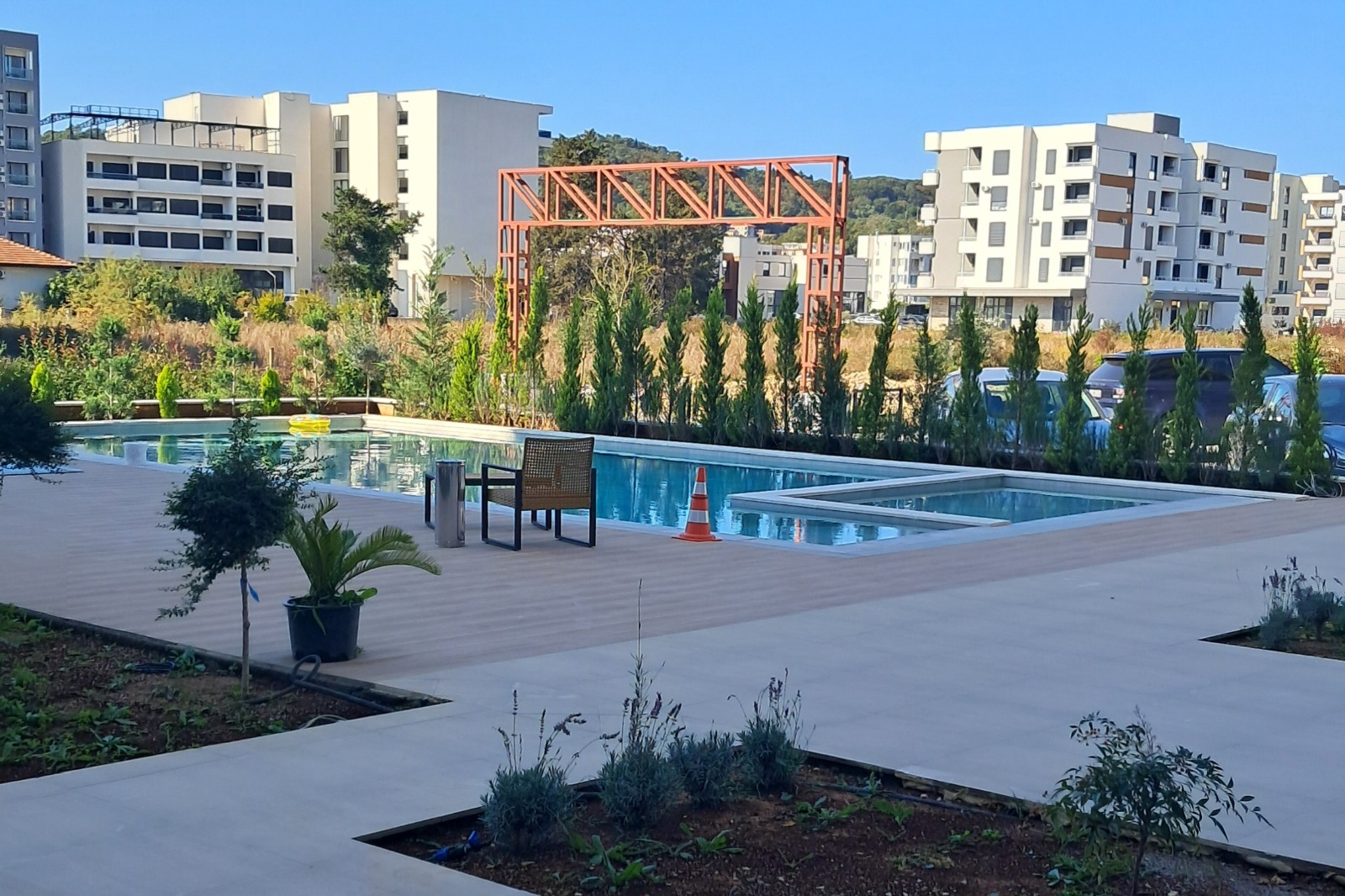 Luxurious Ulcinj pool area with lounge chairs, lush greenery, and modern apartments—exclusive listings on montenegro-listings.me by Ekosphere DOO. Luxurious Ulcinj pool area with lounge chairs, lush greenery, and modern apartments—exclusive listings on montenegro-listings.me by Ekosphere DOO.