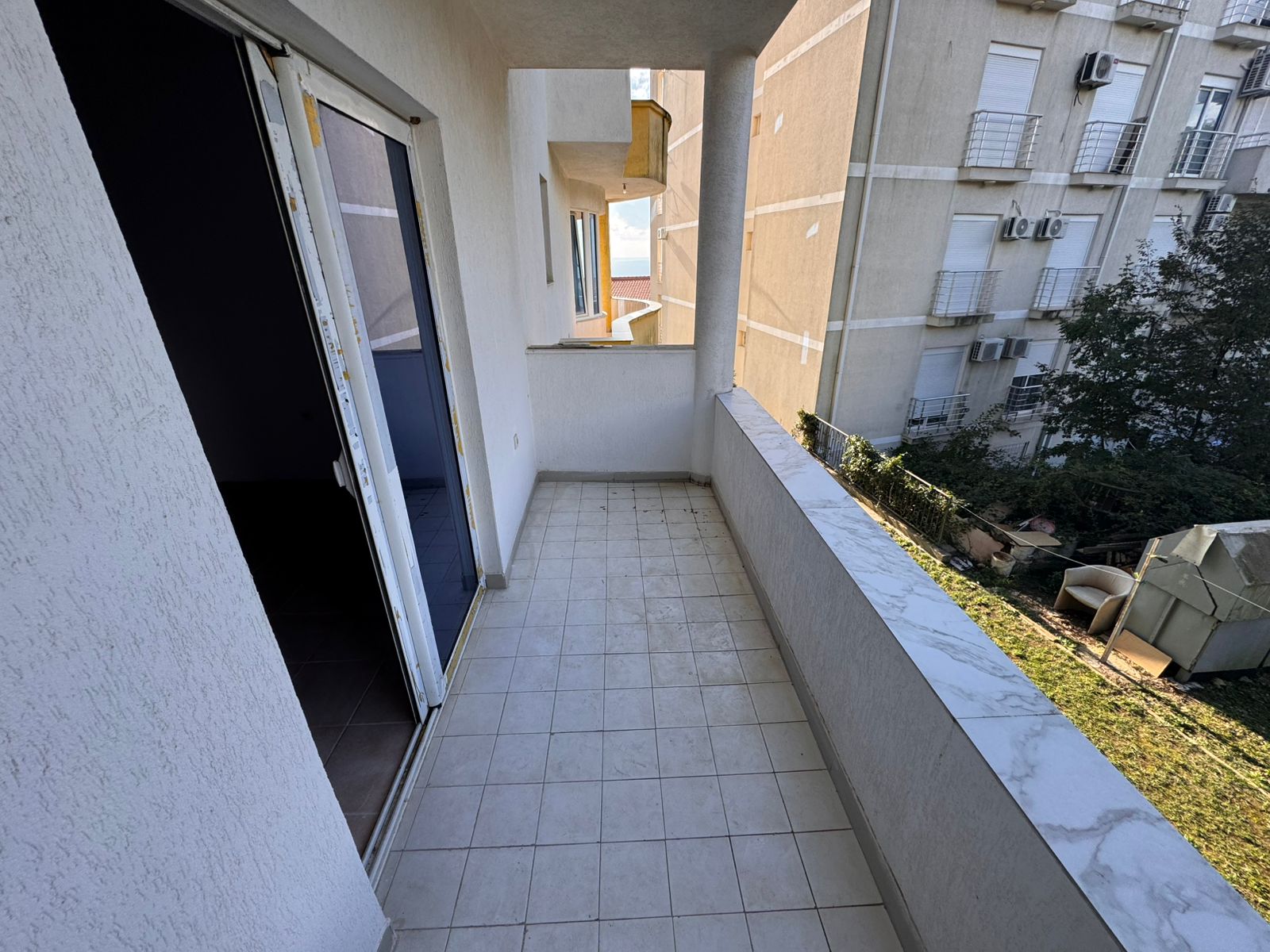 Spacious tiled balcony with marble railing, sliding glass door, city views&mdash;prime Ulcinj real estate by montenegro-listings.me/Ekosphere doo.