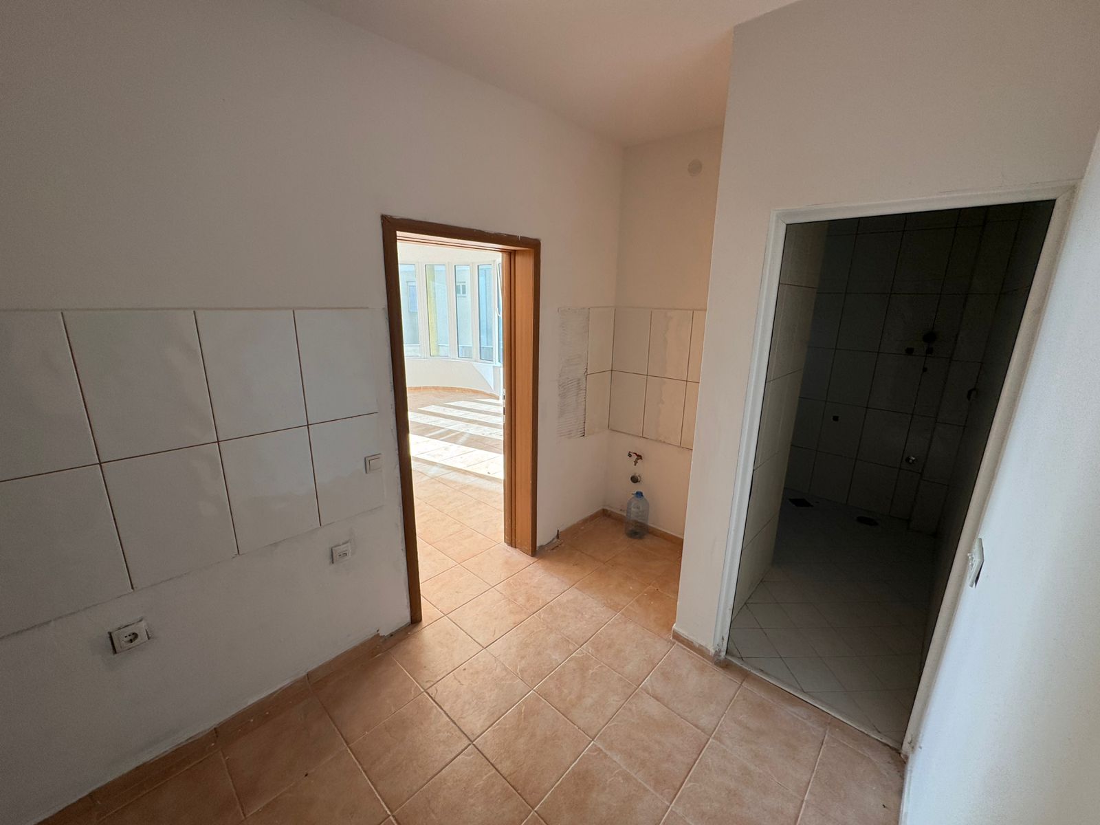 Bright, modern tiled space with beige floors, large sunlit windows; ideal Ulcinj investment on montenegro-listings.me by ekosphere doo.