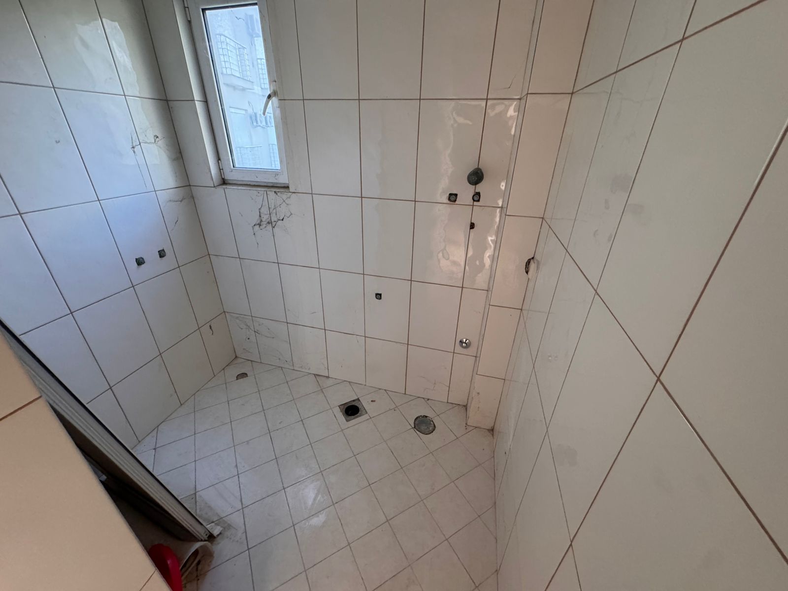 Bright, tiled bathroom in Ulcinj with window and plumbing&mdash;ideal for customizing. Great investment via montenegro-listings.me by ekosphere doo.