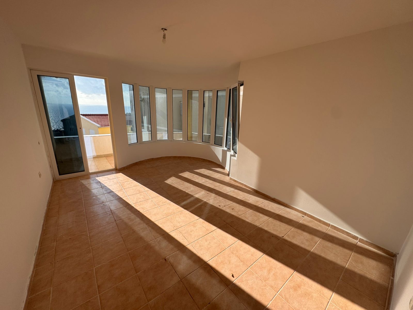 Experience bright, modern living in Ulcinj: spacious sunlit room with panoramic windows, balcony access, exclusive on montenegro-listings.me by ekosphere doo.