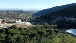 Charming Ulcinj village homes with red roofs, lush hills, stunning valley views—prime Montenegro real estate at montenegro-listings.me by ekosphere doo.