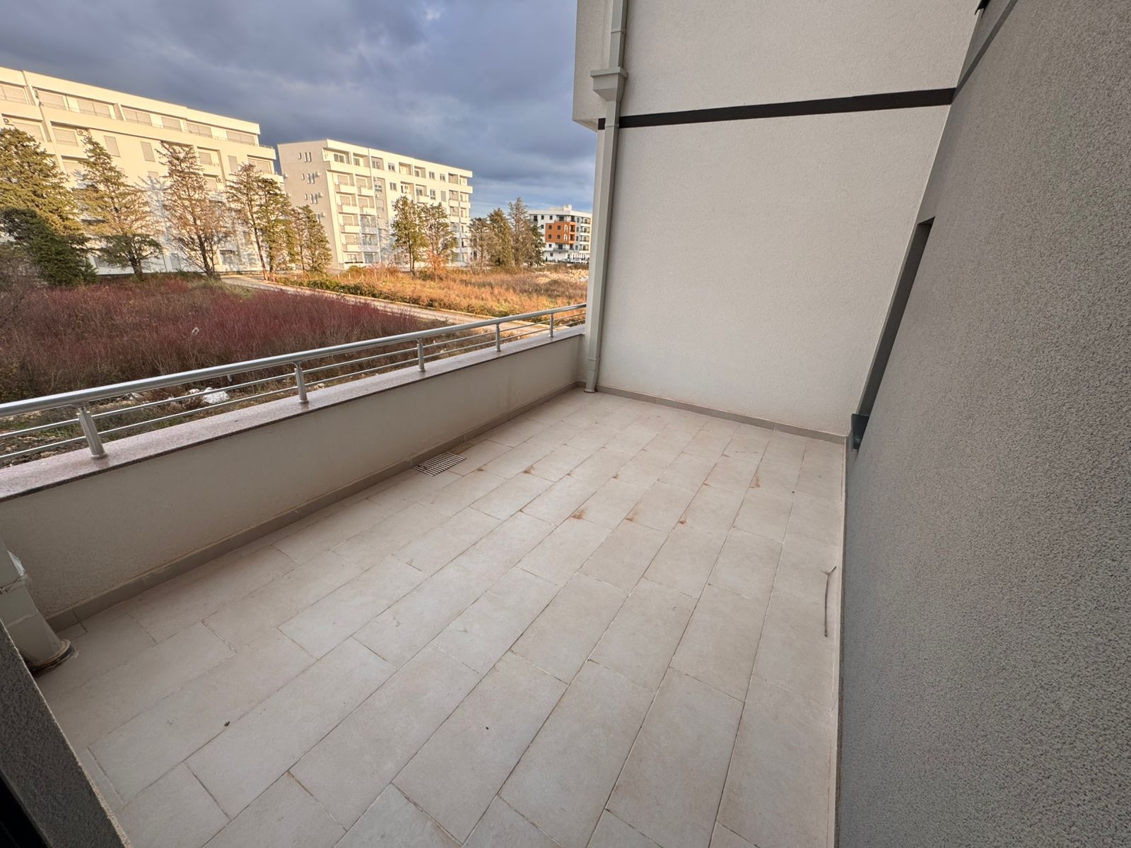 Expansive modern balcony with sleek railing, tiled floors, and scenic Ulcinj views&mdash;ideal property from ekosphere doo on montenegro-listings.me.