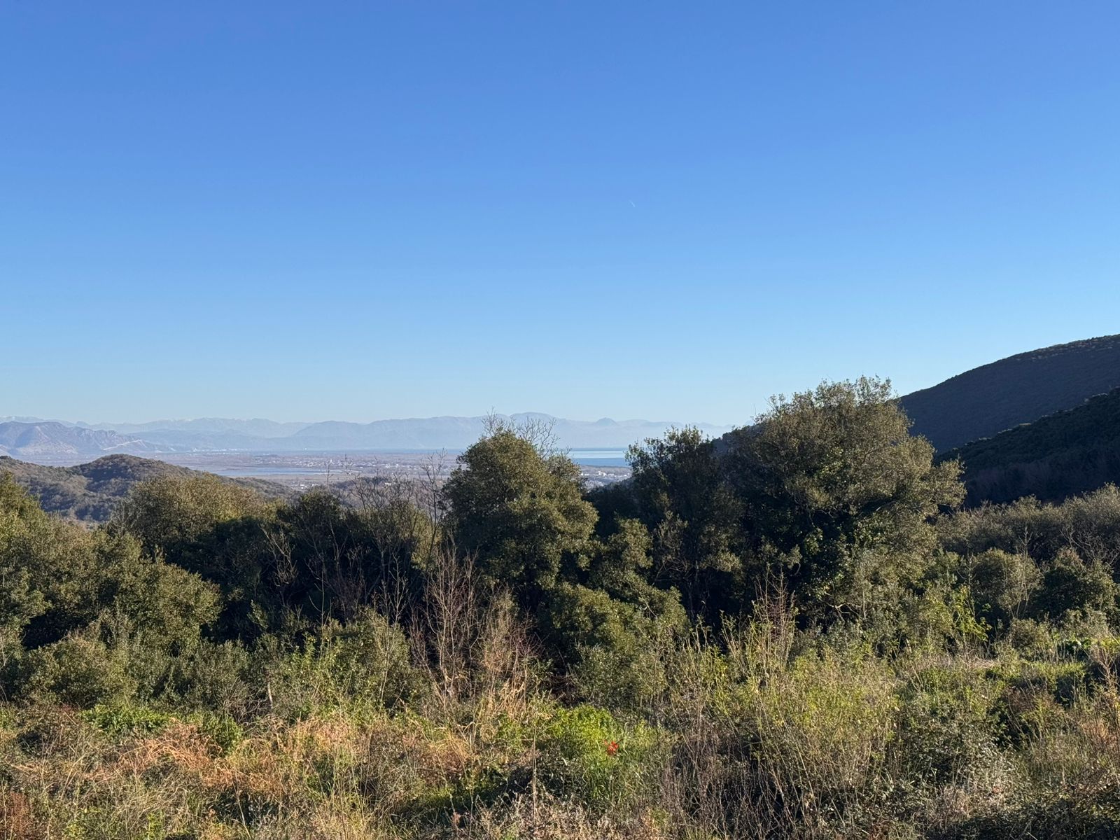 Stunning Ulcinj property view: lush greenery, rolling hills, cityscape, and mountains&mdash;ideal real estate investment. Ekosphere doo project.