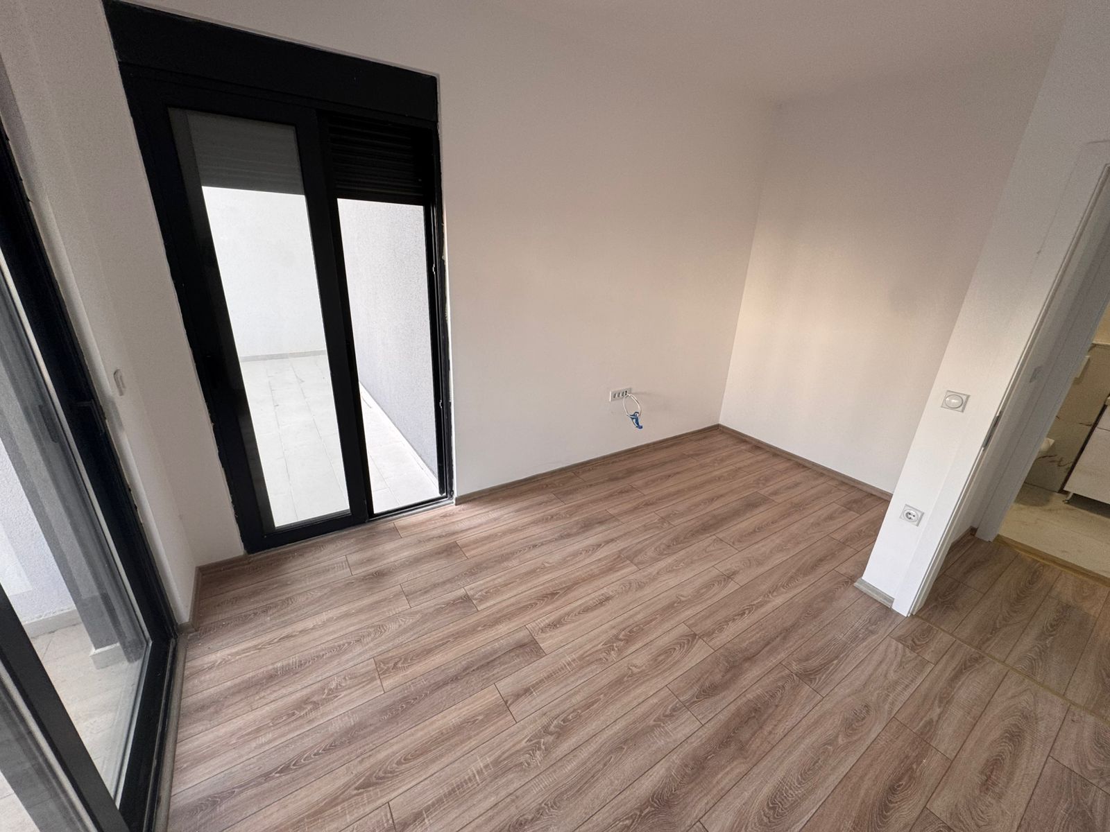 Bright, modern room in Ulcinj with premium wood floors, glass door to outdoor space&mdash;ideal Montenegro investment. eksosphere doo project.