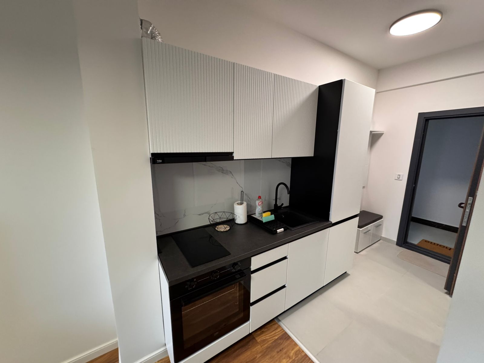 Sleek Ulcinj kitchen: white cabinets, marble backsplash, built-in oven. Prime Montenegro investment via montenegro-listings.me/Ekosphere doo.