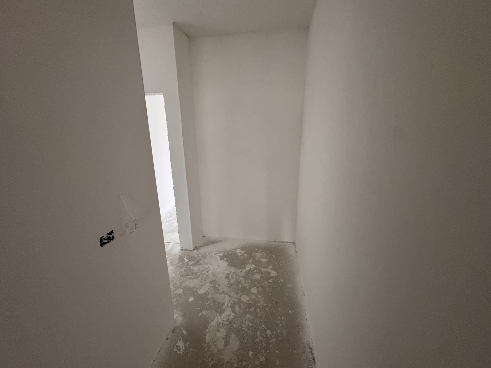Spacious hallway in an Ulcinj investment property with white drywall, concrete floor, and open layout&mdash;exclusive on montenegro-listings.me by ekosphere doo.
