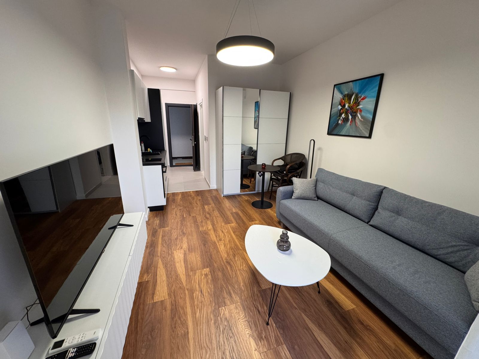 Bright, modern Ulcinj living room with wooden floors, gray sofa, ample storage. Exclusive on montenegro-listings.me by ekosphere doo.
