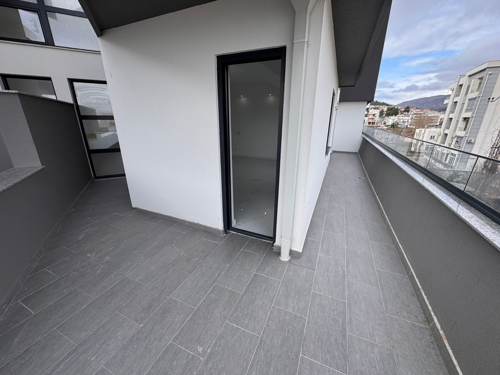 Modern, spacious balcony with sleek glass railings in Ulcinj. Ideal Montenegro investment&mdash;exclusive via montenegro-listings.me by ekosphere doo.