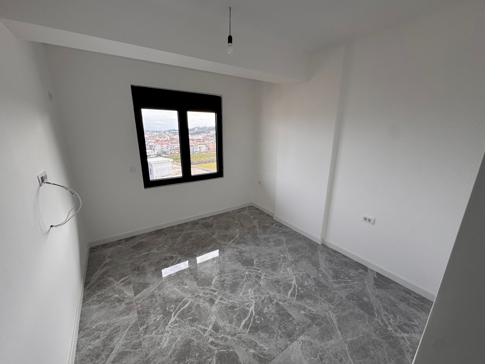Spacious, sunlit room in Ulcinj with sleek white walls, modern marble flooring, energy features&mdash;exclusive at montenegro-listings.me by ekosphere doo.