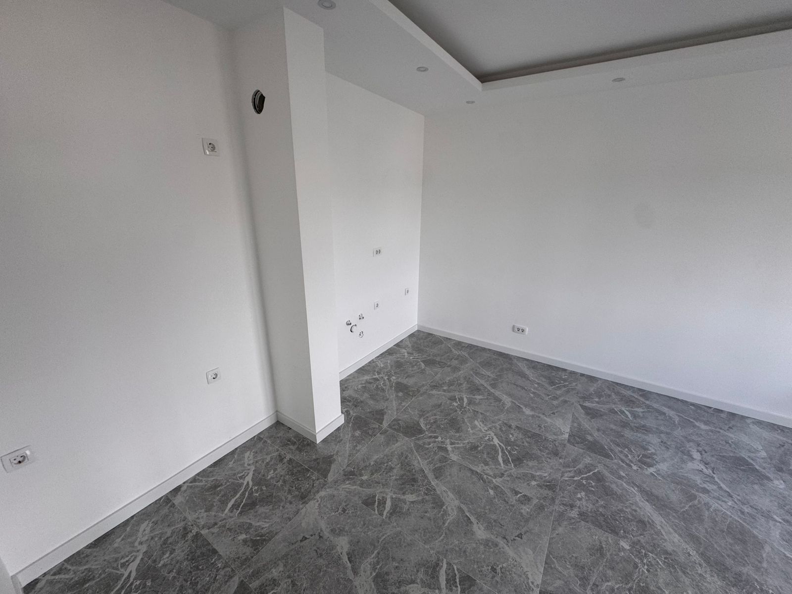 Modern, move-in ready room in Ulcinj with sleek marble-tiled floor, recessed lighting&mdash;ideal Montenegro investment from ekosphere doo.