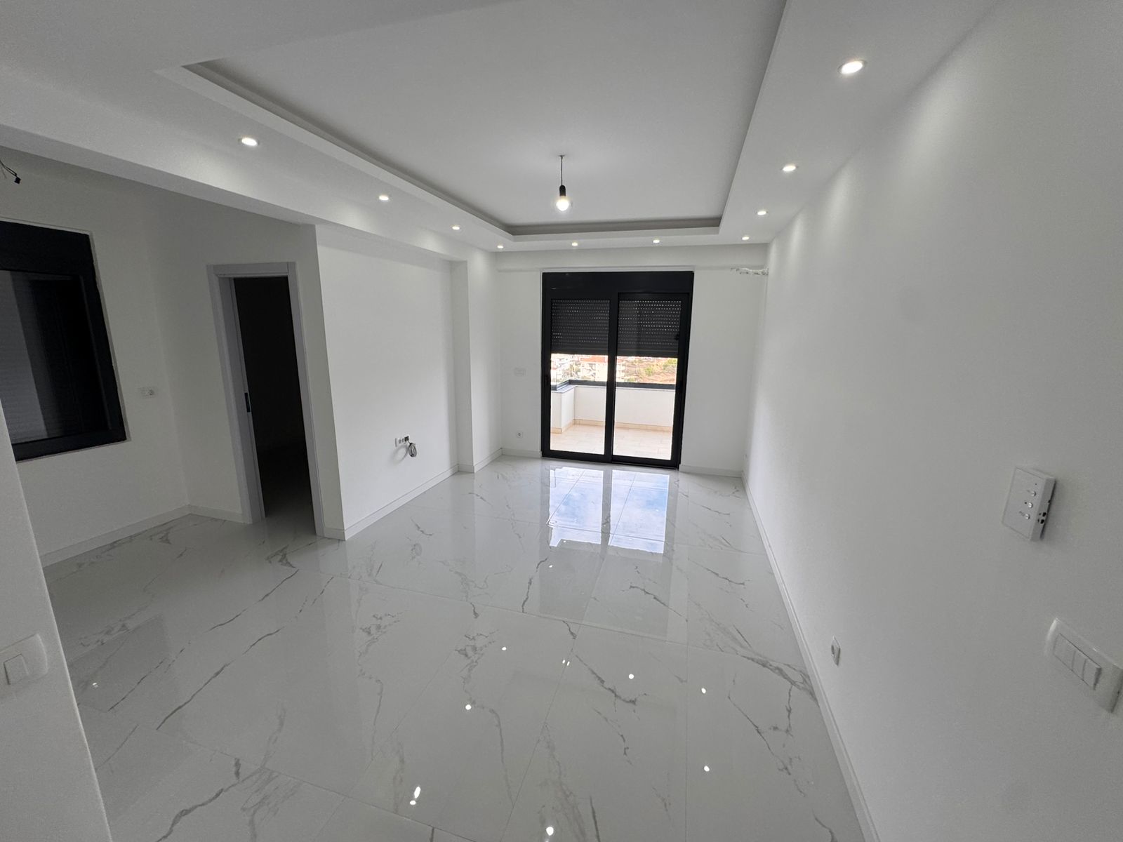 Contemporary room in Ulcinj with marble floors, large windows, balcony access. Premium investment at montenegro-listings.me by ekosphere doo.