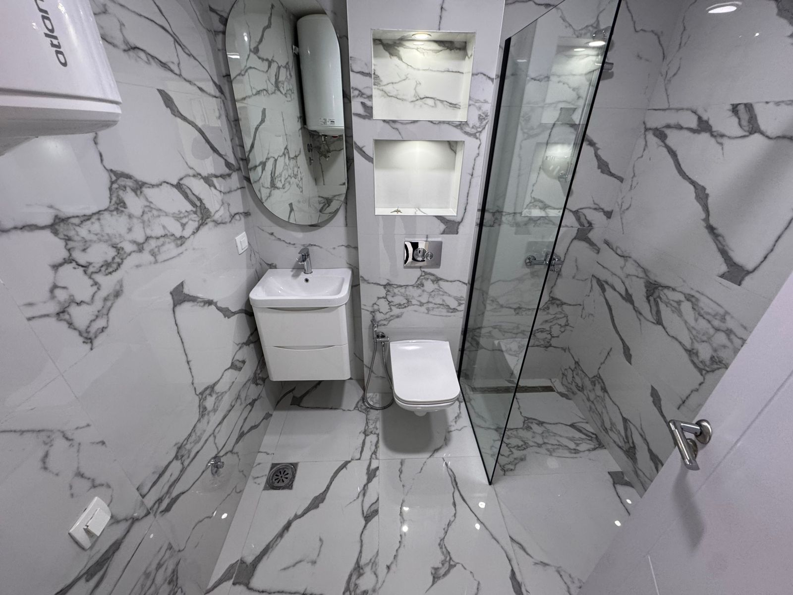 Elegant modern bathroom in Ulcinj with marble tiles, premium fixtures, ideal investment. Exclusive at montenegro-listings.me by ekosphere doo.