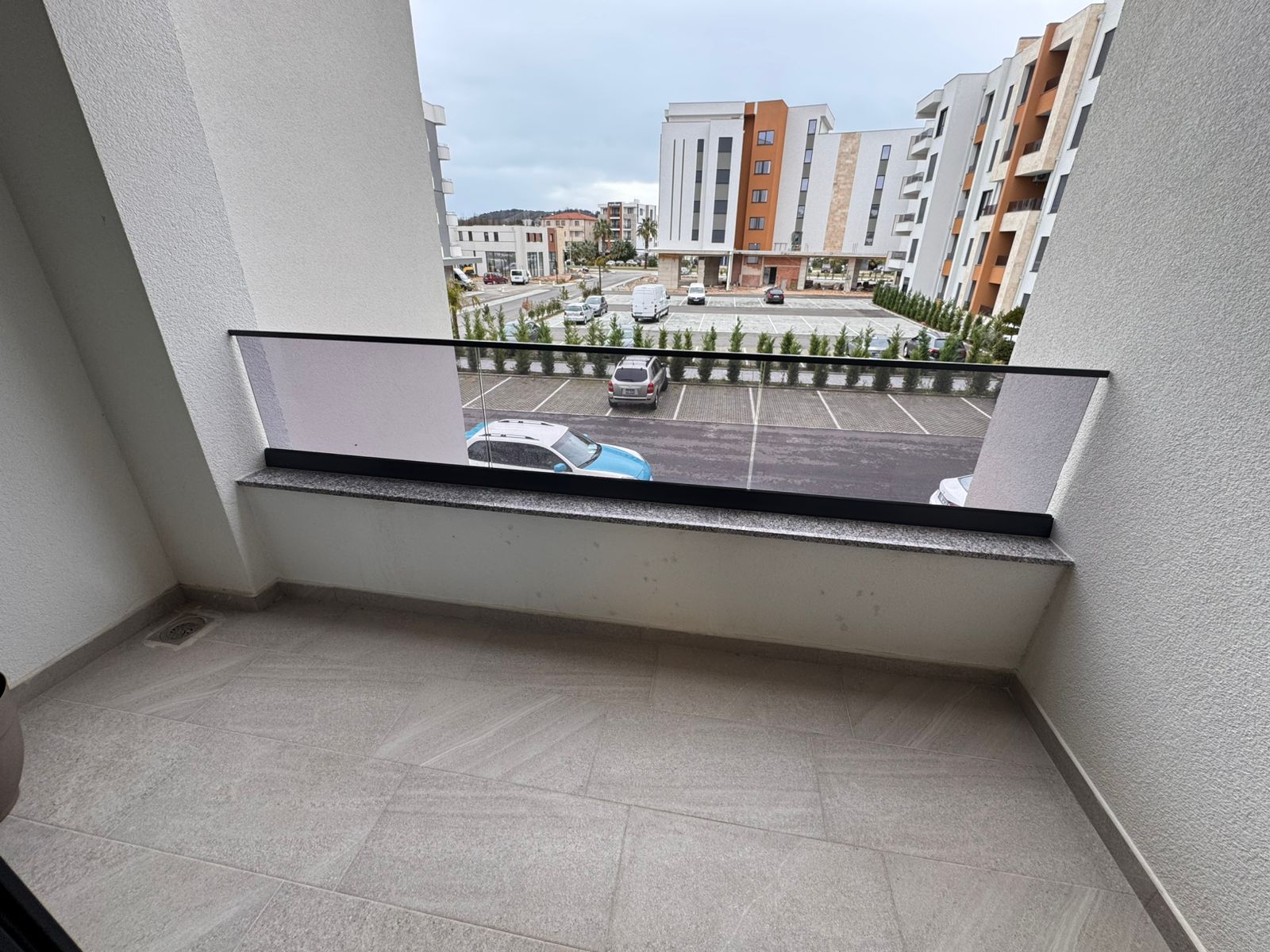 Bright tiled balcony in Ulcinj with modern apartment views—prime real estate ideal for investment. Listed by montenegro-listings.me, a project of ekosphere doo.