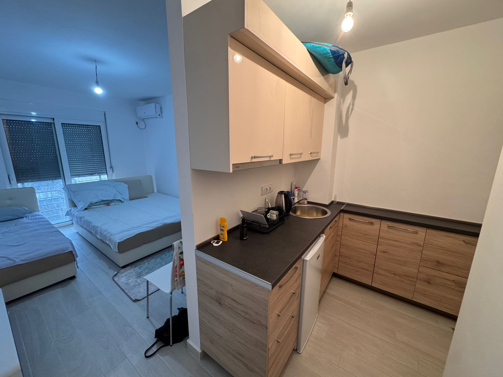 Modern studio apartment in Ulcinj: bed, sofa, wood kitchen, large windows. Ideal investment via montenegro-listings.me by ekosphere doo.