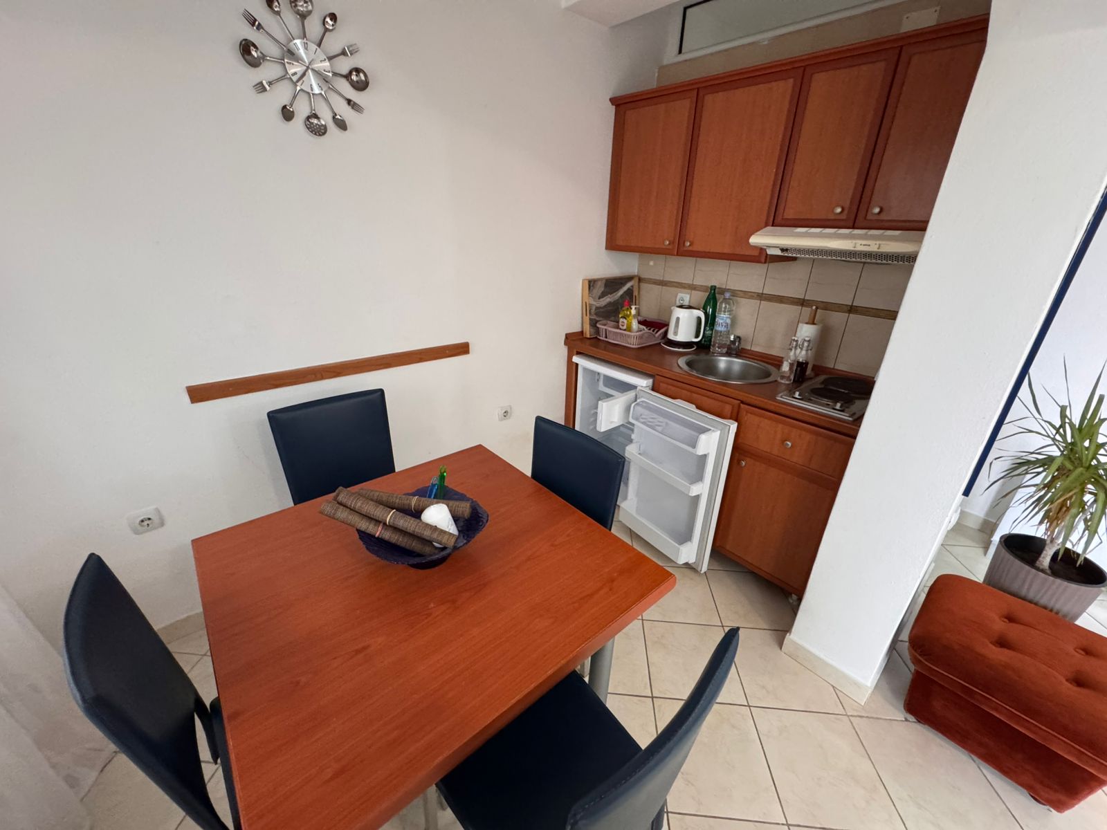 Modern kitchen and dining space in Ulcinj with sleek kitchenette, quality furniture, tiled floors—ideal Montenegro investment by ekosphere doo.
