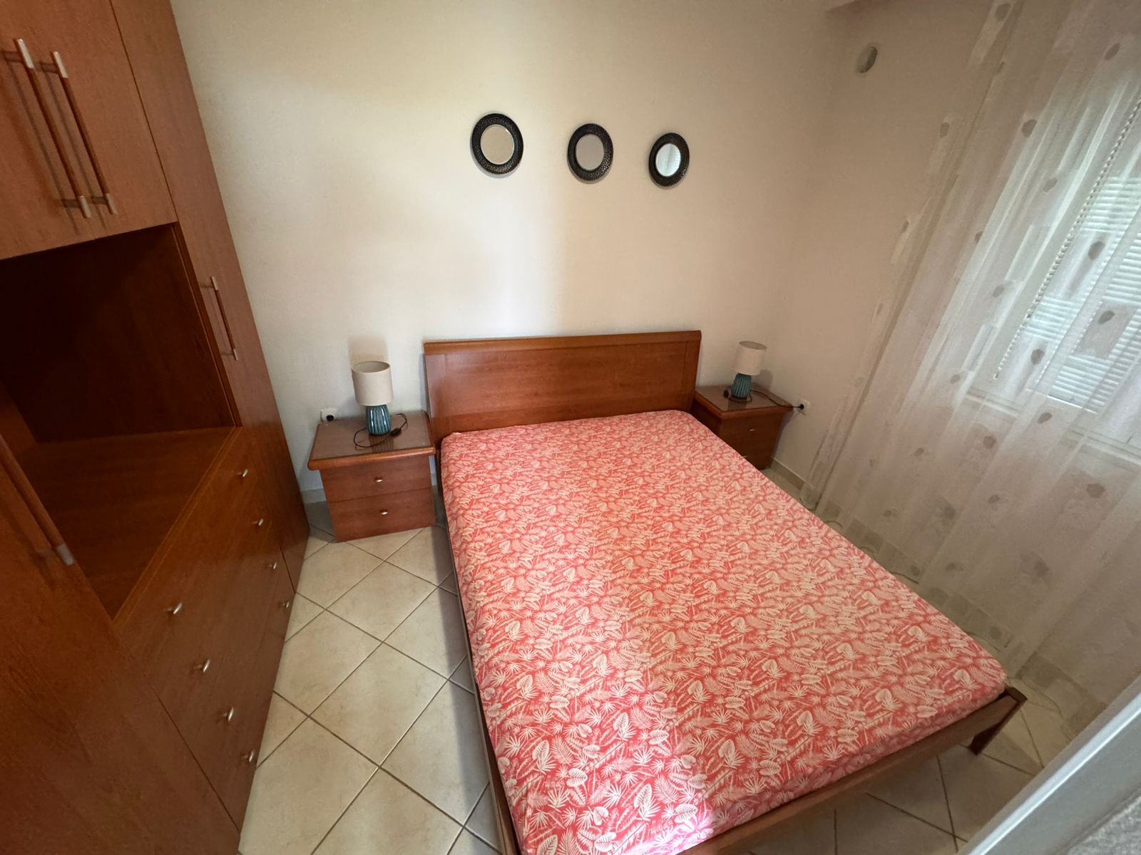 Modern Ulcinj bedroom with wooden double bed, designer decor, wardrobe, tiled floor. Invest via montenegro-listings.me by ekosphere doo.