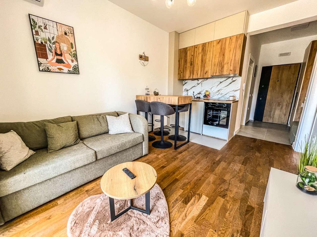 Discover this stylish Ulcinj apartment: modern living room, chic kitchen, elegant floors&mdash;ideal Montenegro real estate investment.