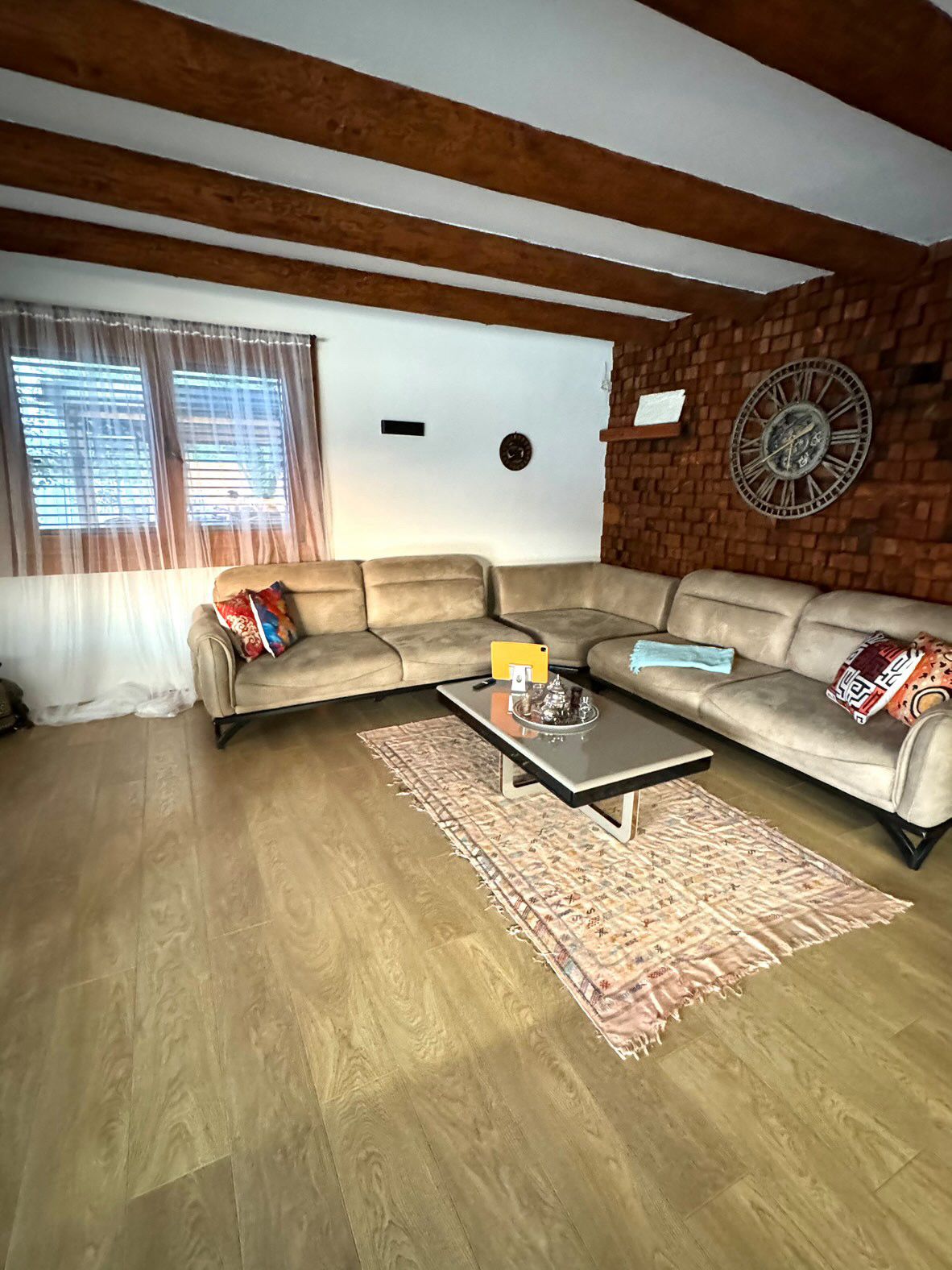 Elegant Ulcinj living room with modern sofa, stylish beams, accent wall&mdash;exclusive on montenegro-listings.me by ekosphere doo.