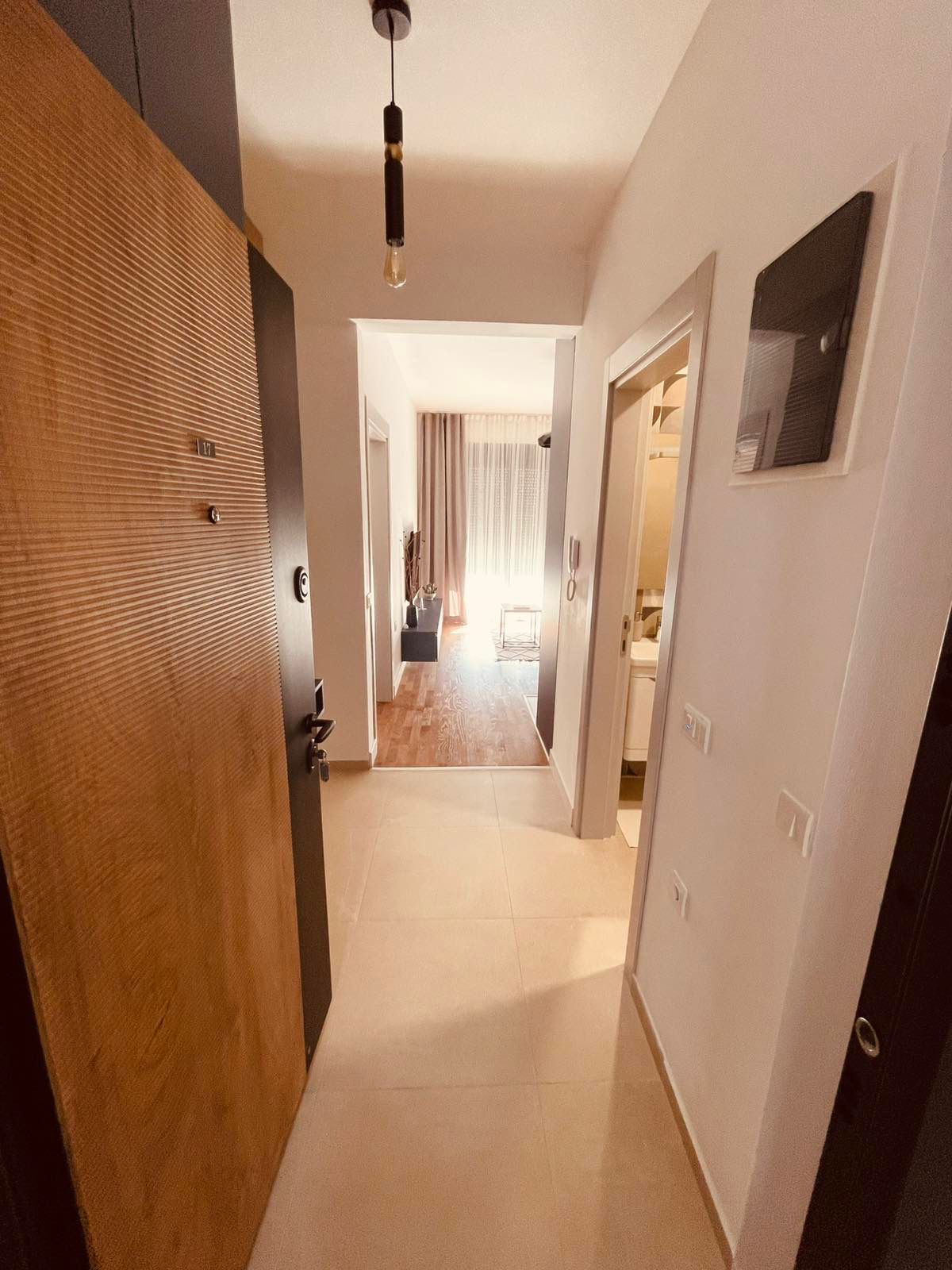 Bright hallway with elegant tile floors flows to a wood-floored living area; ideal Ulcinj investment by ekosphere doo, montenegro-listings.me.