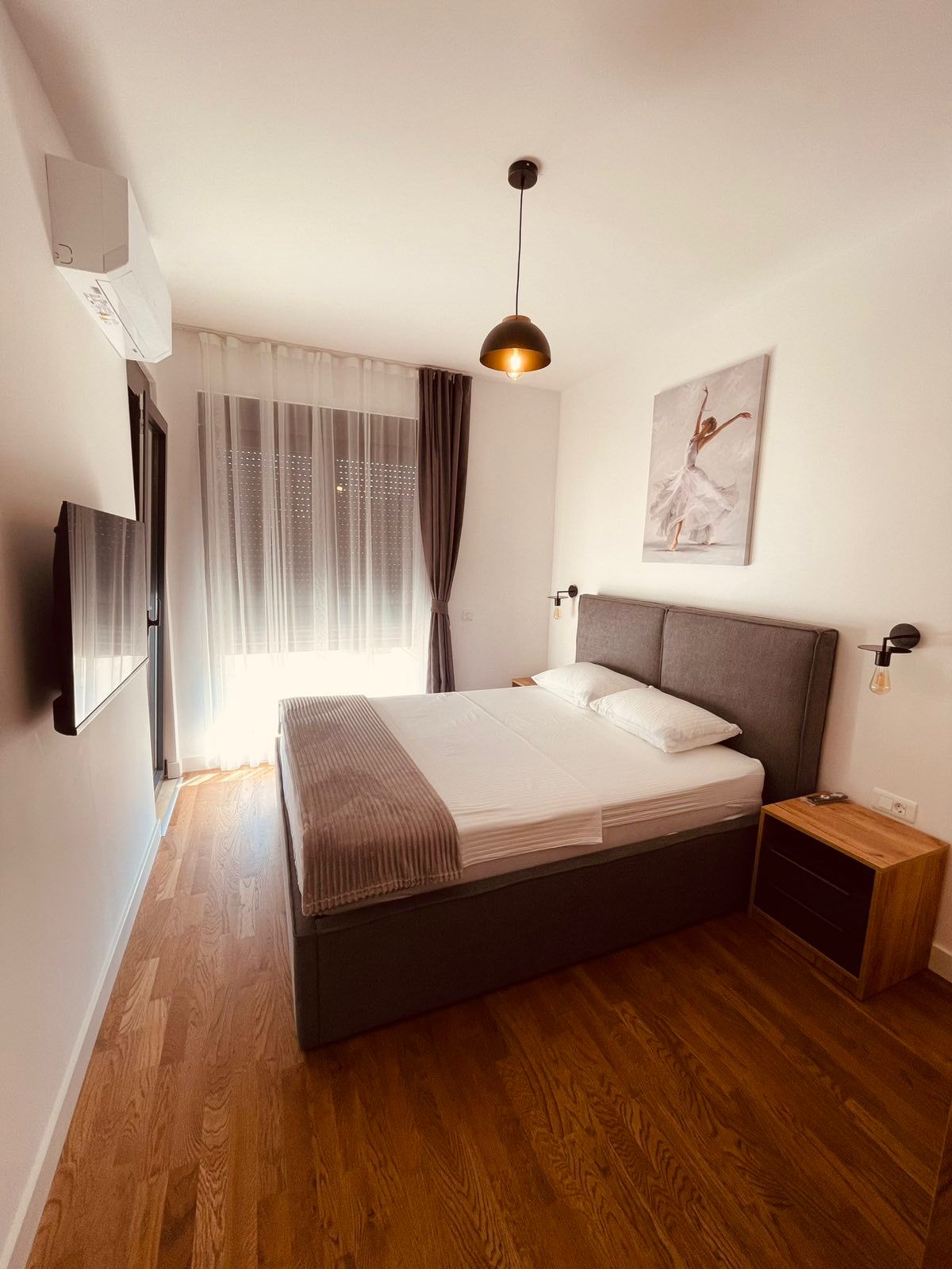 Elegant Ulcinj bedroom with double bed, stylish decor, wood floors&mdash;ideal Montenegro investment. Listed by ekosphere doo.