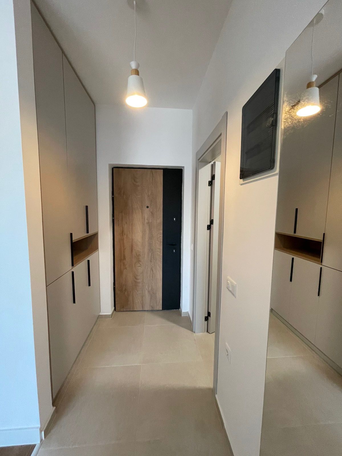 Modern Ulcinj hallway with light tile floors, stylish beige cabinetry, premium finishes&mdash;exclusive at montenegro-listings.me by ekosphere doo.