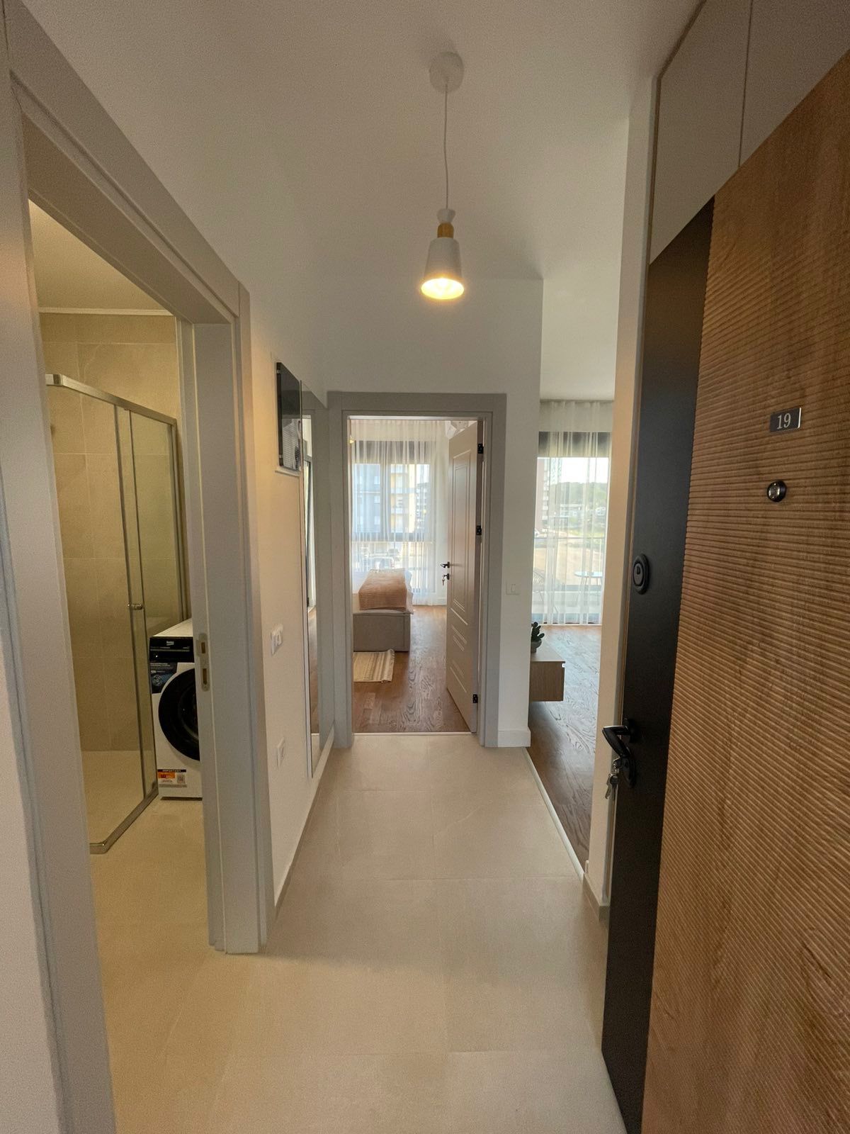 Modern Ulcinj apartment: bright hallway, stylish bath with glass shower, open-plan living area. Exclusive on montenegro-listings.me.