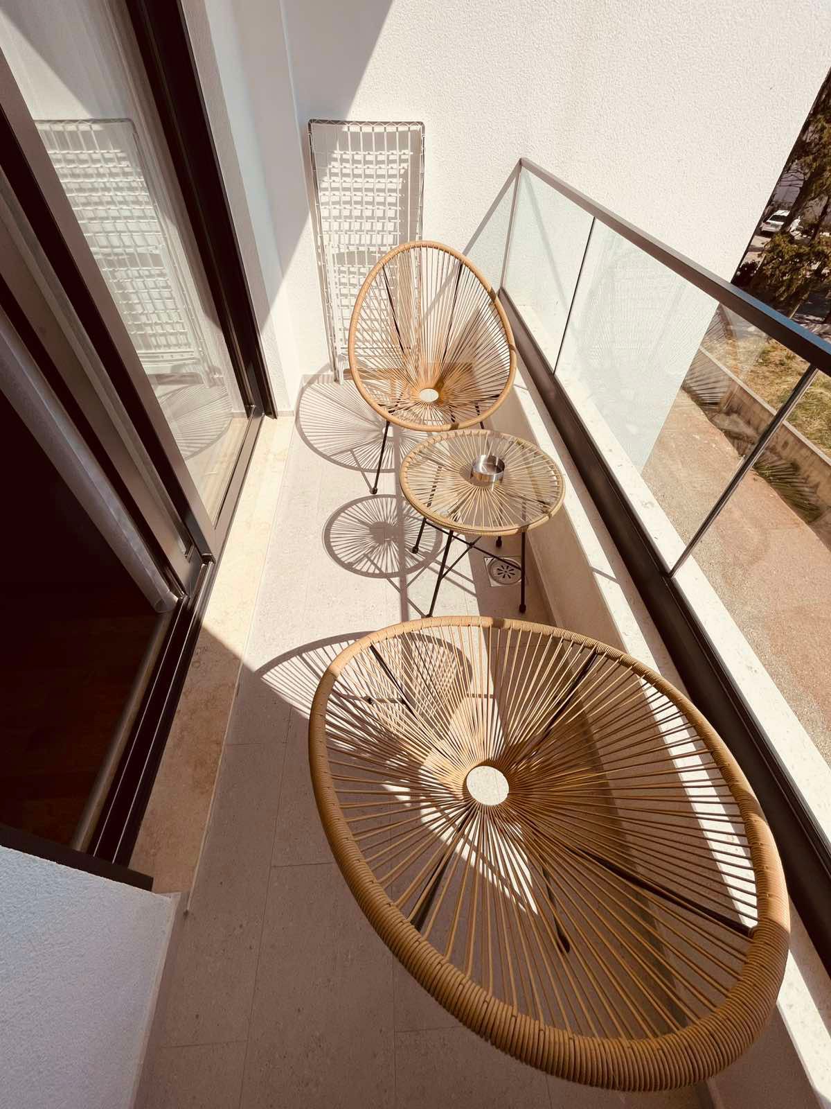 Spacious balcony in Ulcinj, Montenegro with stylish table and chairs&mdash;ideal real estate investment via montenegro-listings.me by ekosphere doo.