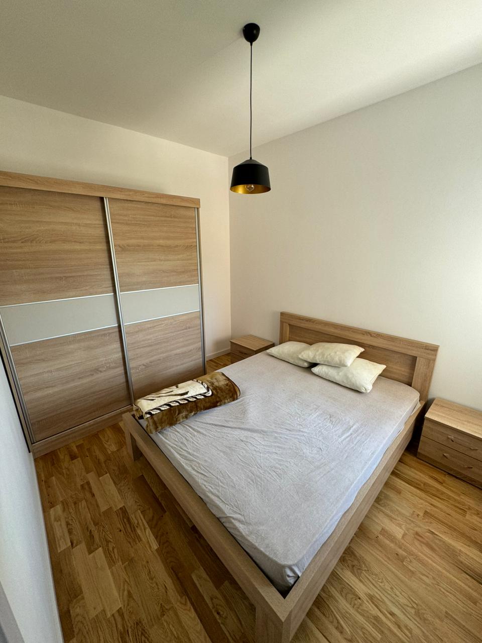 Discover a stylish minimalist Ulcinj bedroom: wood bed, modern furnishings, ideal investment&mdash;exclusively on montenegro-listings.me by ekosphere doo.