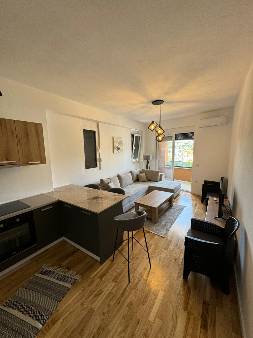 Elegant modern living area with premium finishes, open kitchen, and patio access in Ulcinj&mdash;see more at montenegro-listings.me by ekosphere doo.