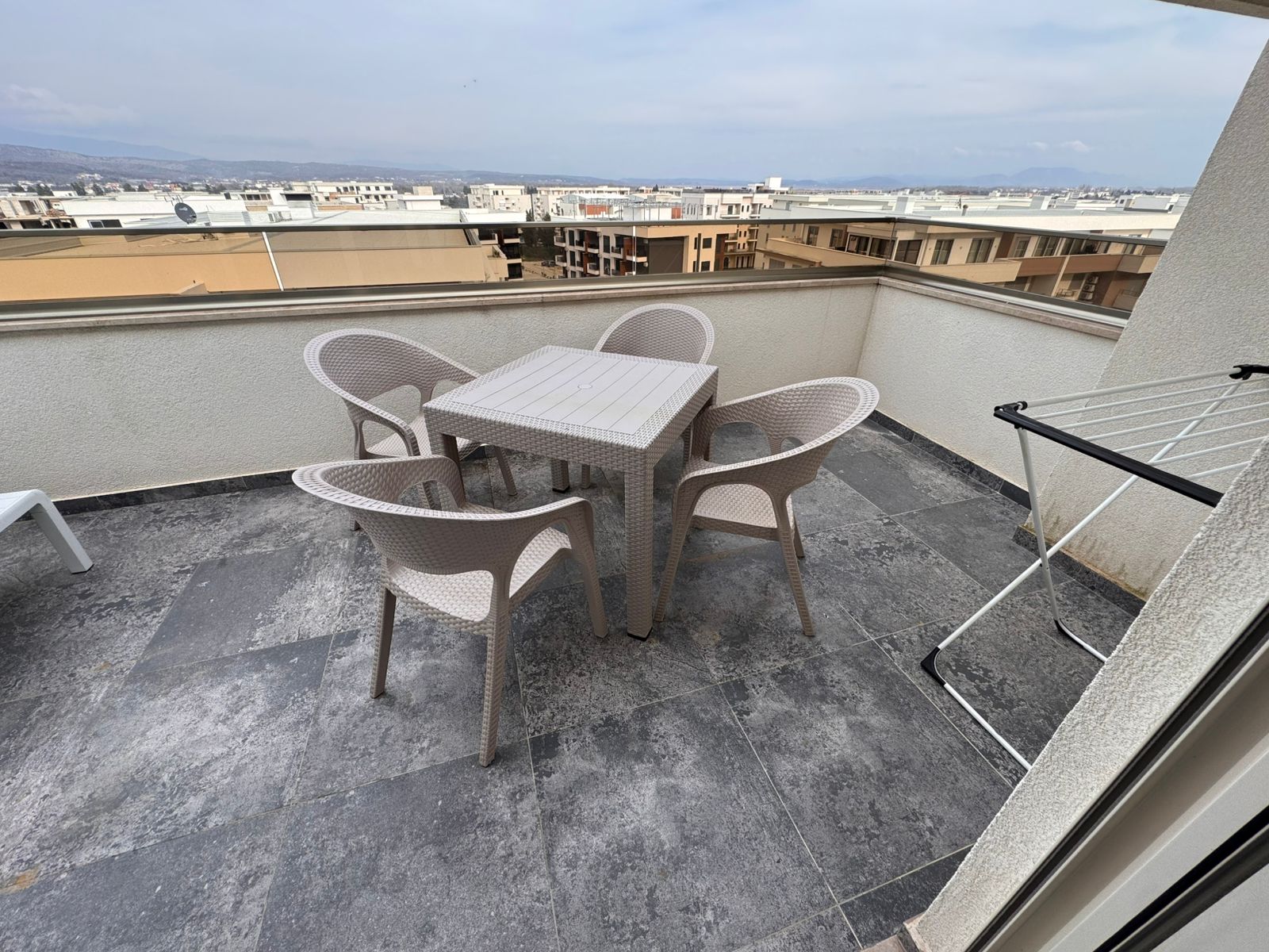 Spacious Ulcinj rooftop terrace with city views, outdoor seating, and secure low wall&mdash;ideal Montenegro investment. Eksophere doo project.