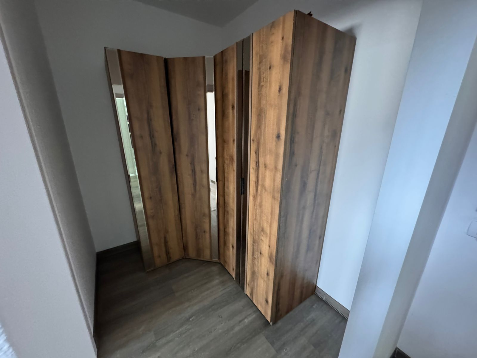 Elegant wooden corner wardrobe with natural finish, ideal for Ulcinj homes. Exclusive at montenegro-listings.me by ekosphere doo.