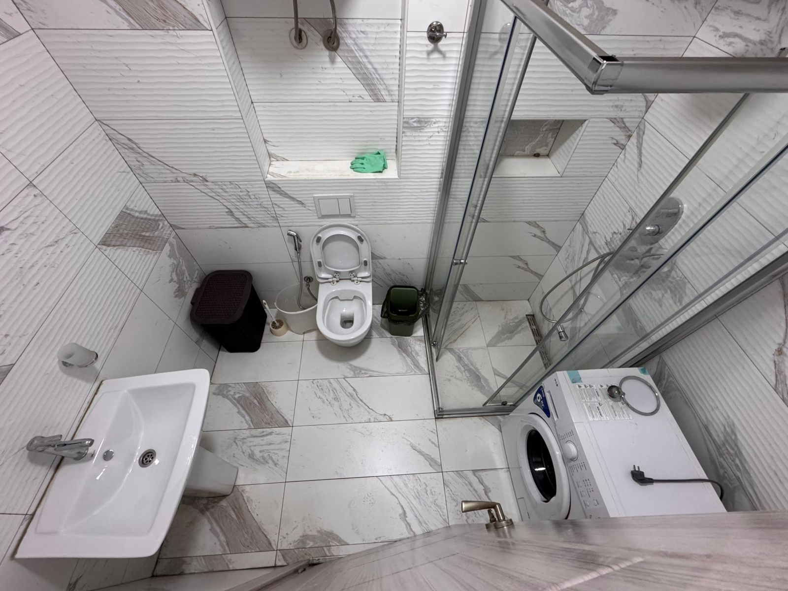 Modern Ulcinj bathroom with elegant tiles, full amenities, glass shower&mdash;prime Montenegro investment via montenegro-listings.me by ekosphere doo.