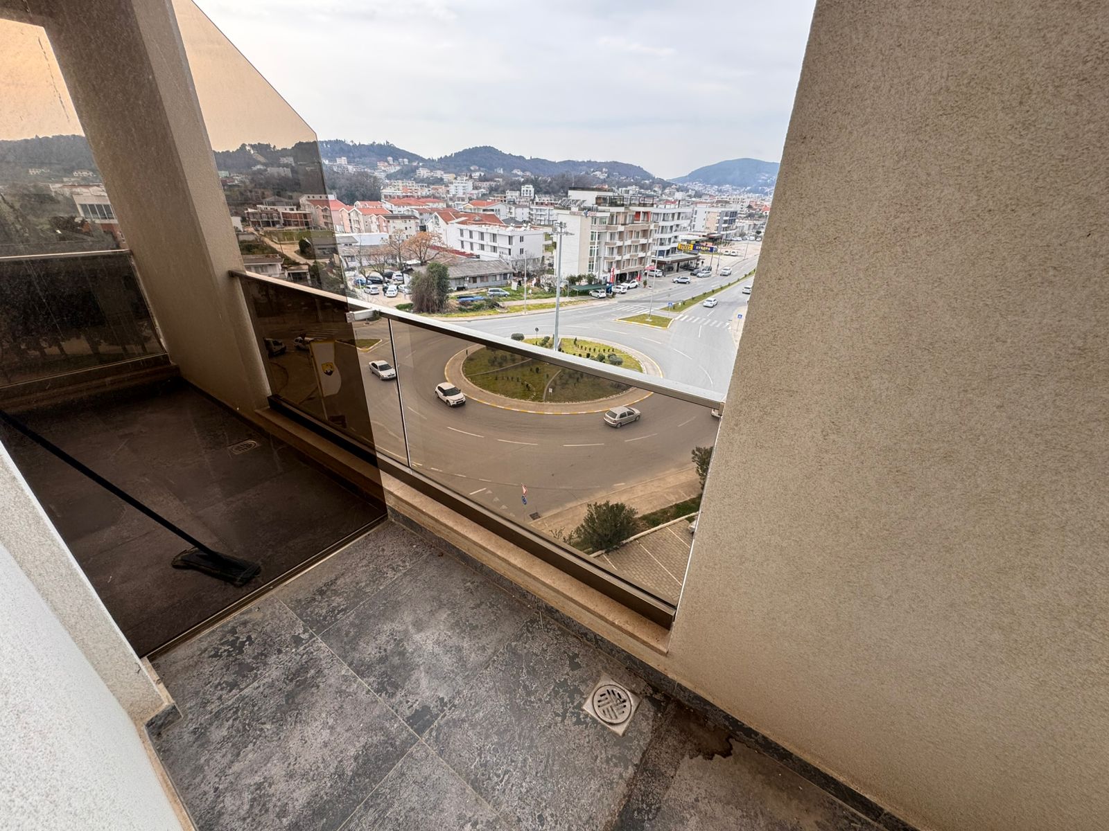 Modern tiled balcony in Ulcinj with urban views, ideal for investment. Listed on montenegro-listings.me by ekosphere doo.
