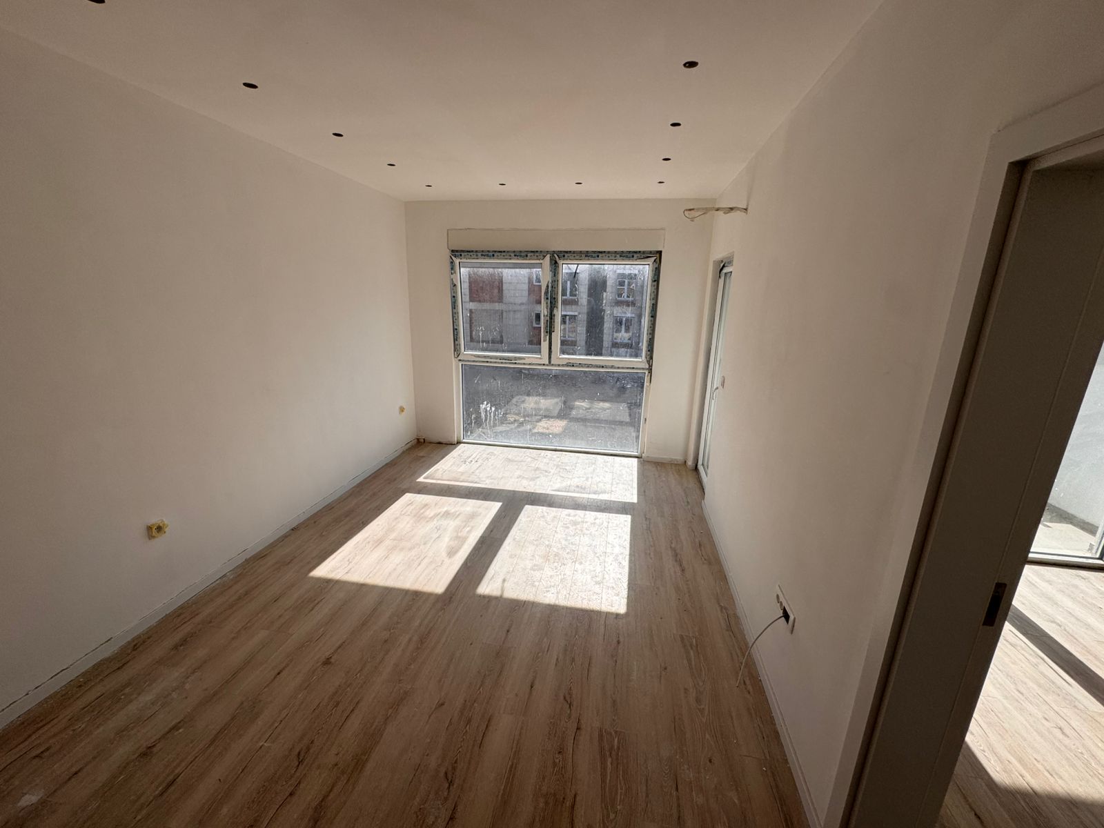 Bright, modern Ulcinj apartment with light wood floors, sunlit windows, and premium features&mdash;exclusive at montenegro-listings.me by ekosphere doo.